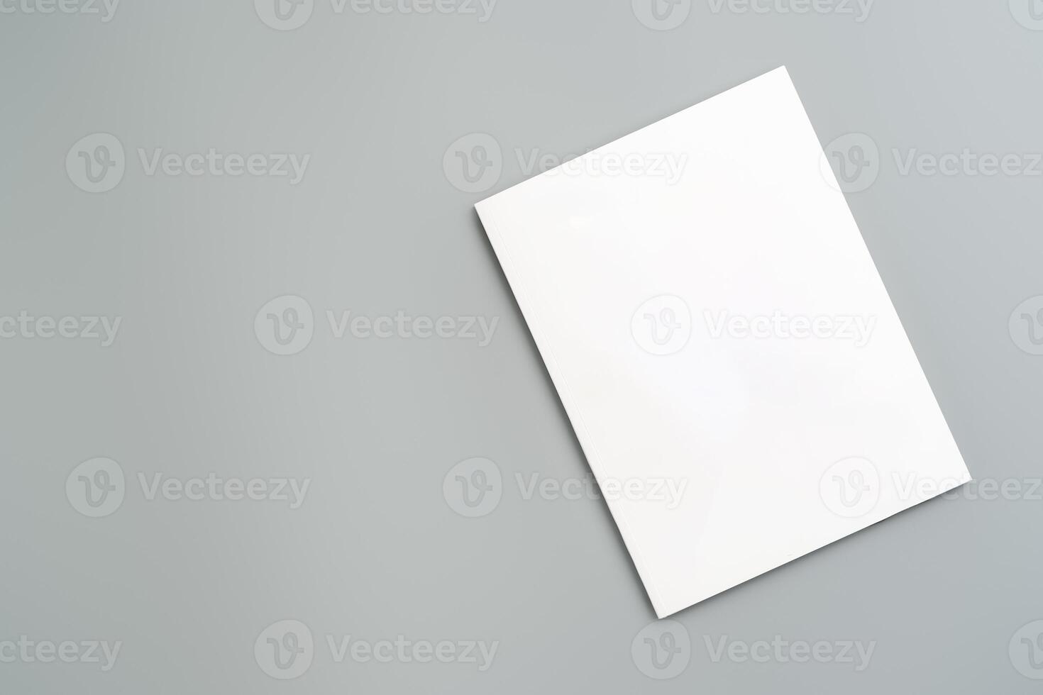 Empty White Sheet of Paper Positioned at an Angle on Light Gray Surface photo