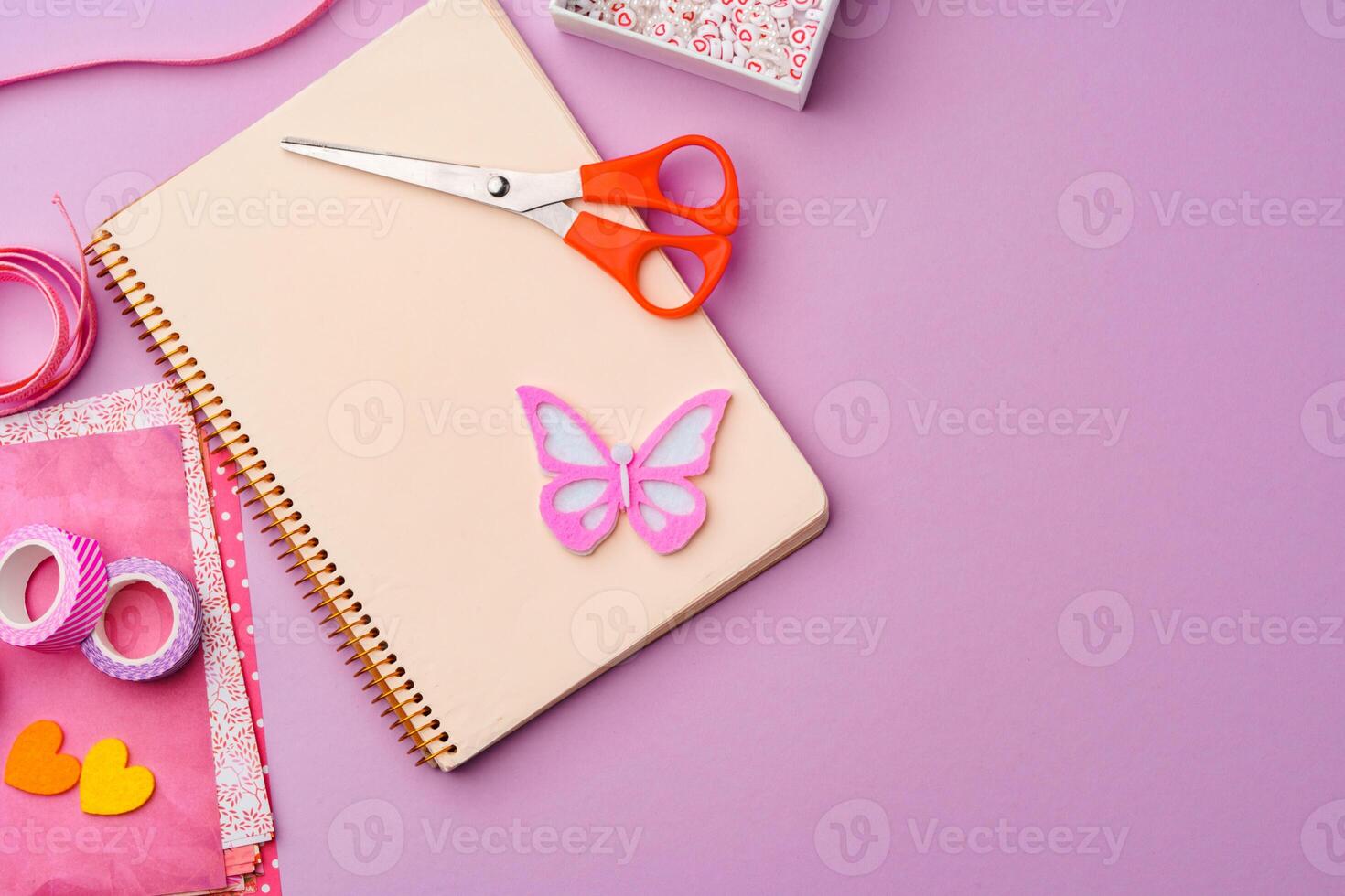 Crafting supplies on a purple background ready for creative projects photo