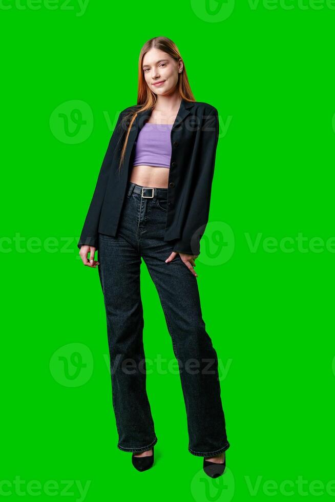 Young Woman Wearing Black Blazer and Purple Top Against Green Screen photo
