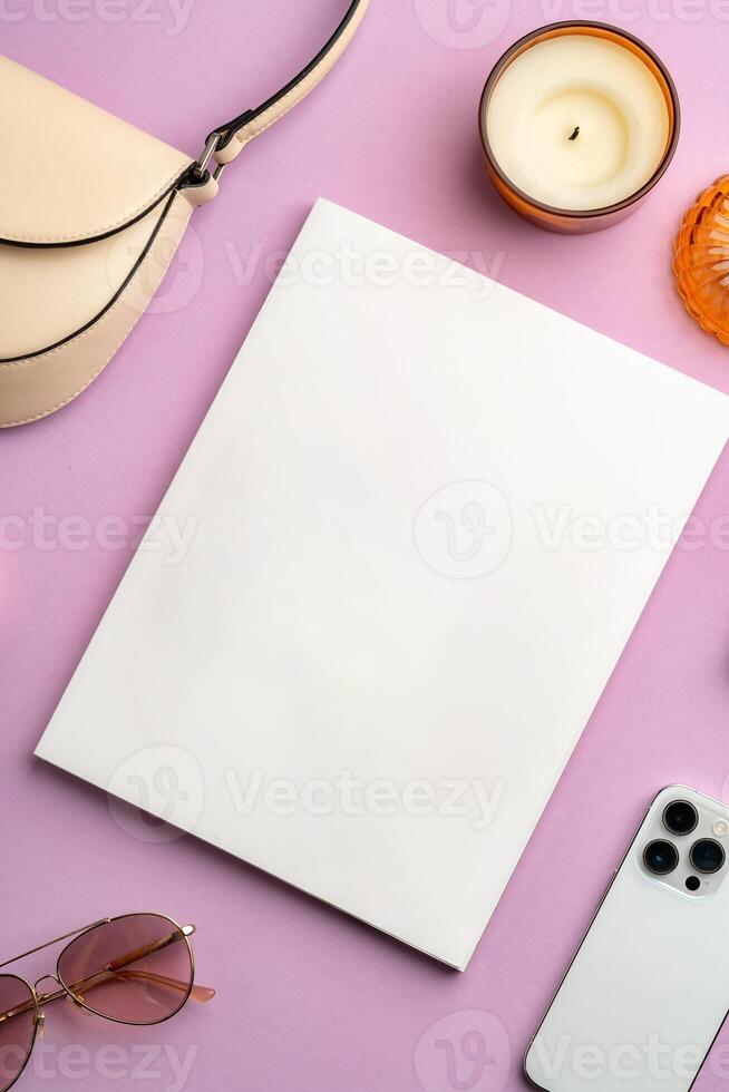 Colorful accessories and a smartphone arranged stylishly on a pastel pink surface photo