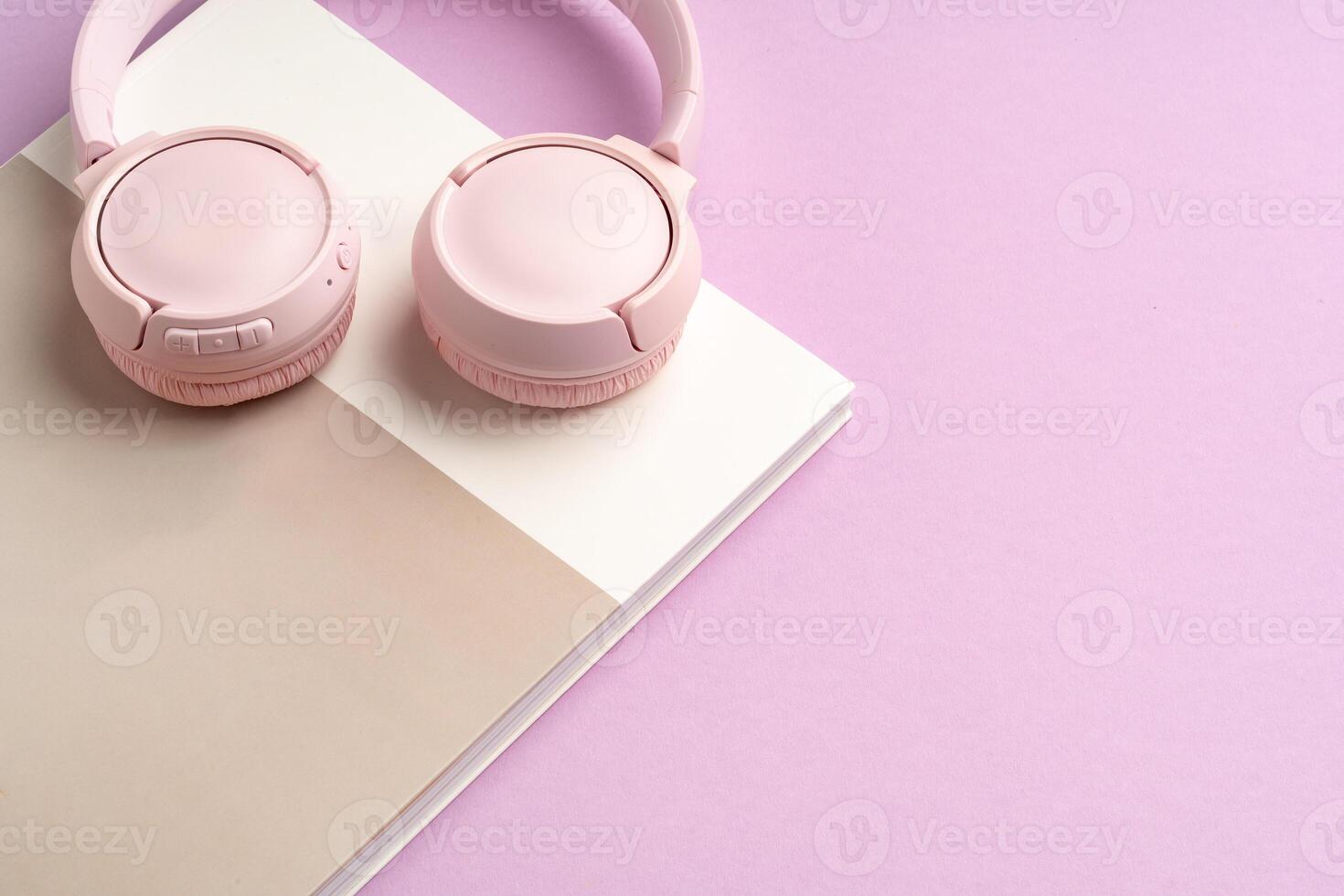 Stylish pink headphones and sunglasses on a pastel background photo