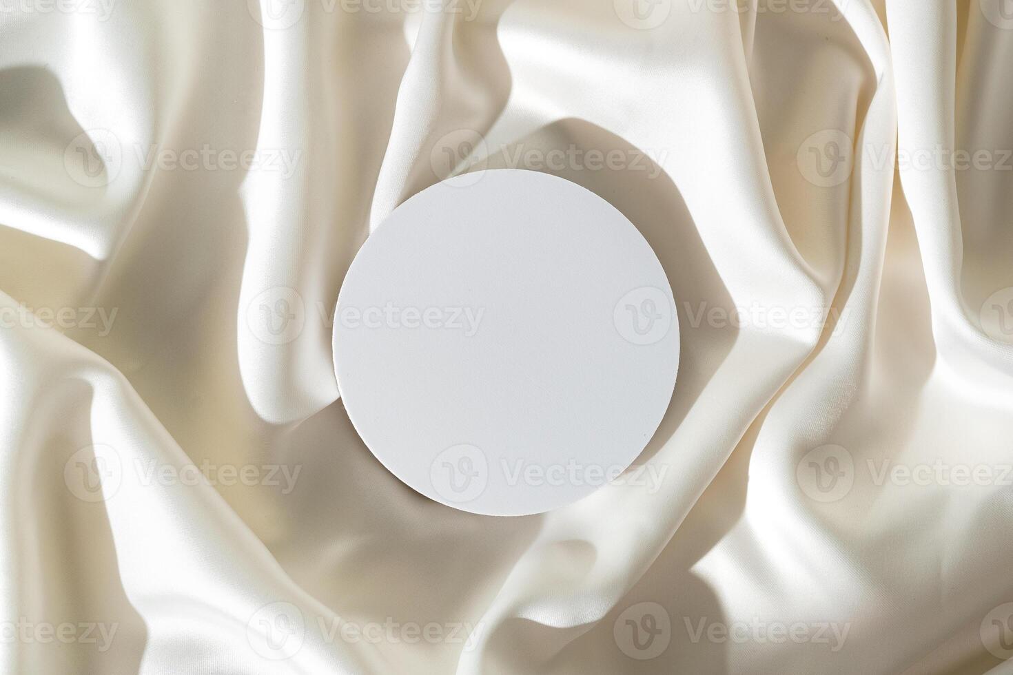 Modern Minimalist White Sculpture Displayed on Soft Draped Fabric in Natural Light photo