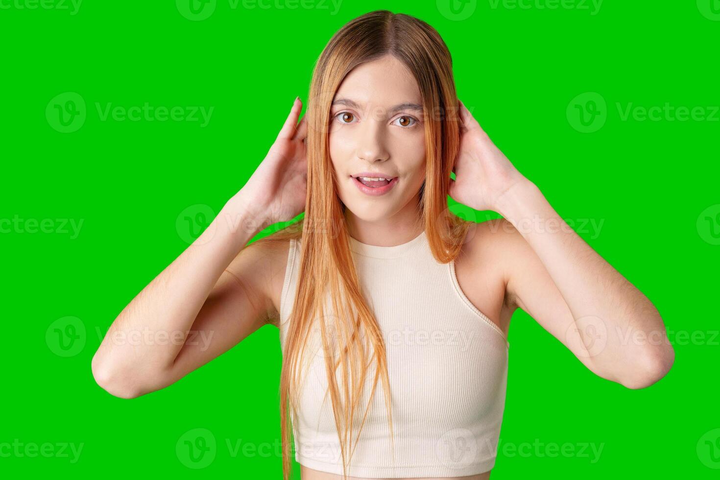 Young Woman With Surprised Expression in Front of Green Screen photo