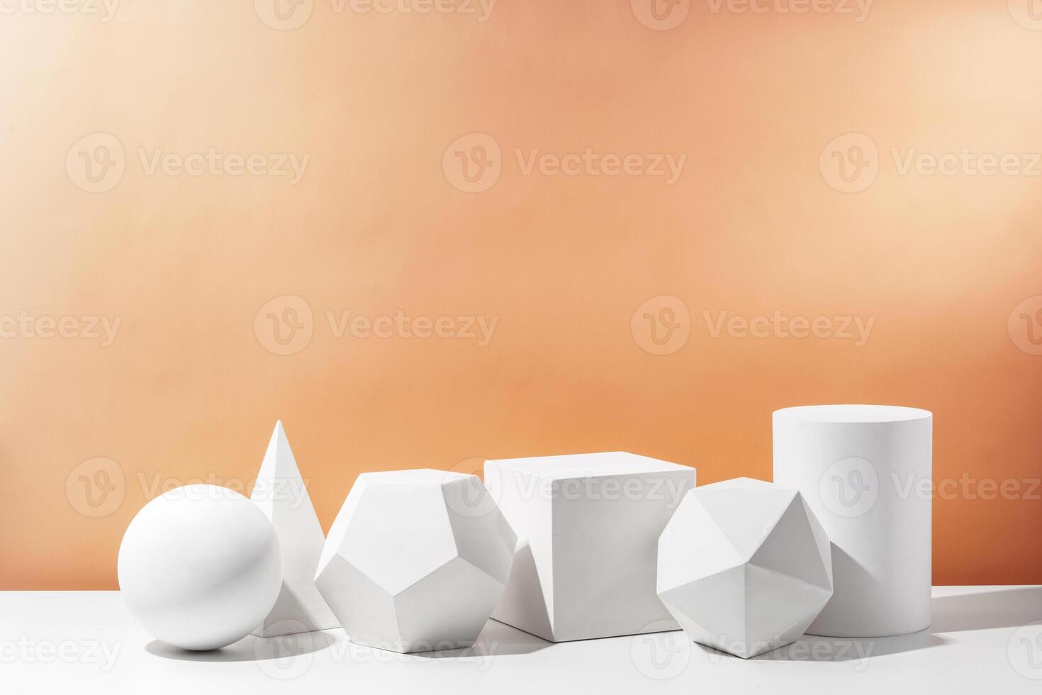 Various geometric shapes arranged artistically on a table with a warm, soft background during daylight photo