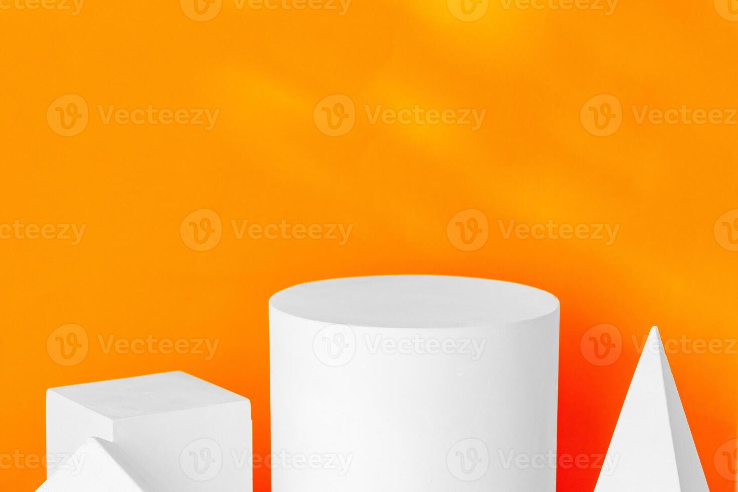 White geometric shapes on a vibrant orange background with soft shadows in a well-lit indoor setting photo