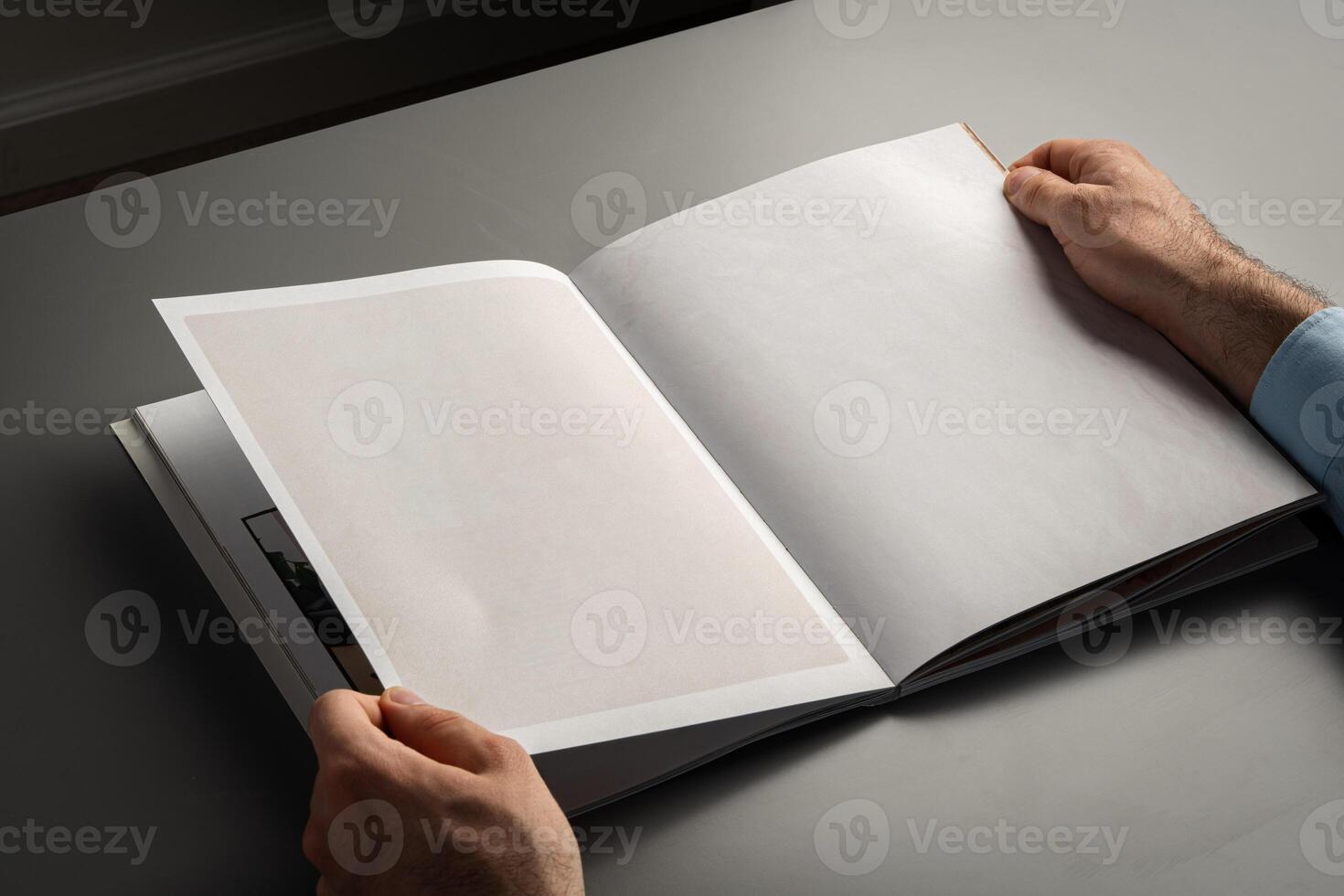 Close Up of Person's Hands Holding Open Book While Sitting photo