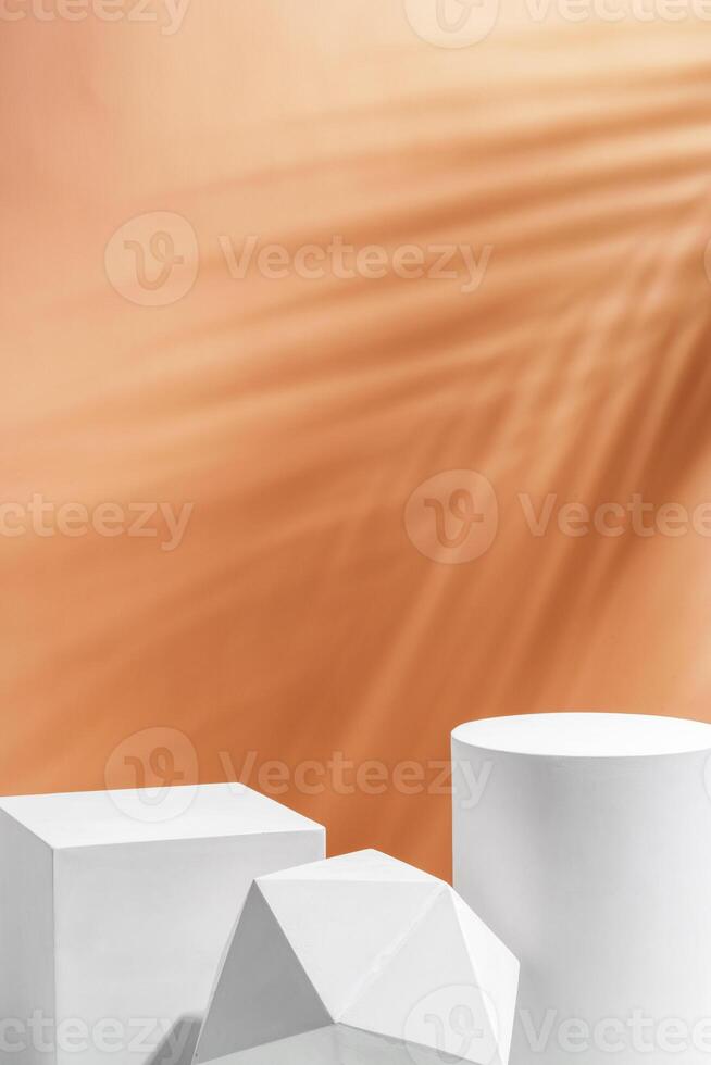 White geometric shapes arranged stylishly on a soft peach background in a minimalist setting photo