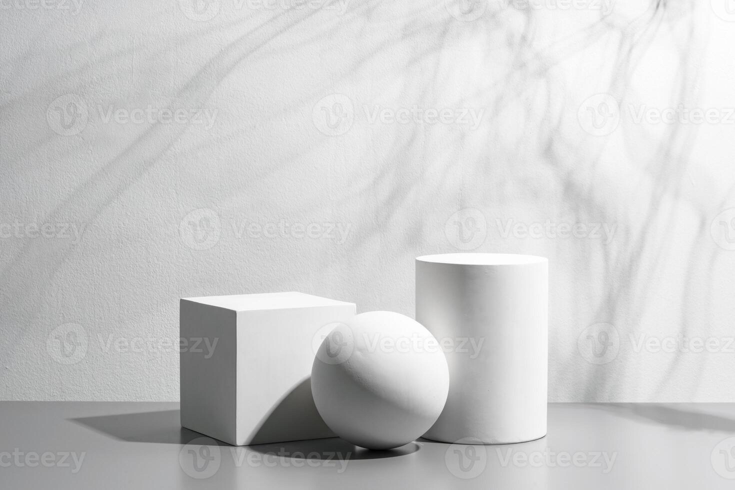 Abstract composition featuring three white geometric shapes in a minimalist interior setting photo