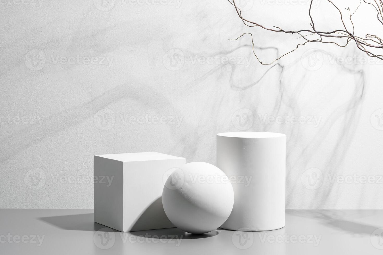 Abstract composition featuring three white geometric shapes in a minimalist interior setting photo
