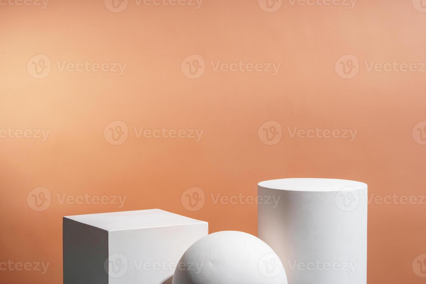 White geometric shapes arranged stylishly on a soft peach background in a minimalist setting photo