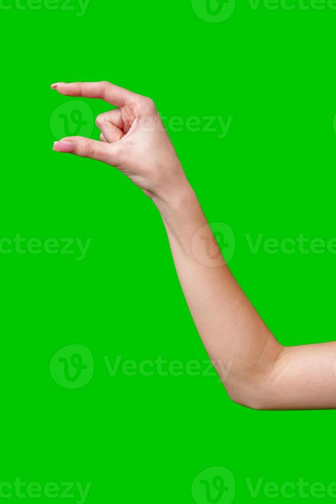 Female Hand Making Gesture Against Green Screen photo