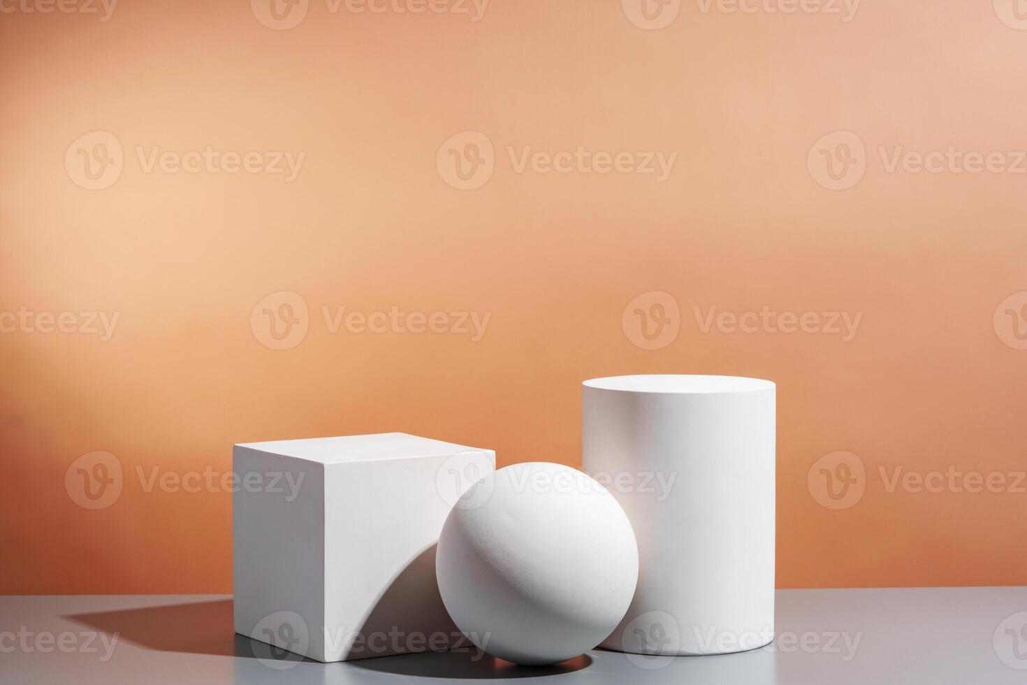 White geometric shapes arranged stylishly on a soft peach background in a minimalist setting photo