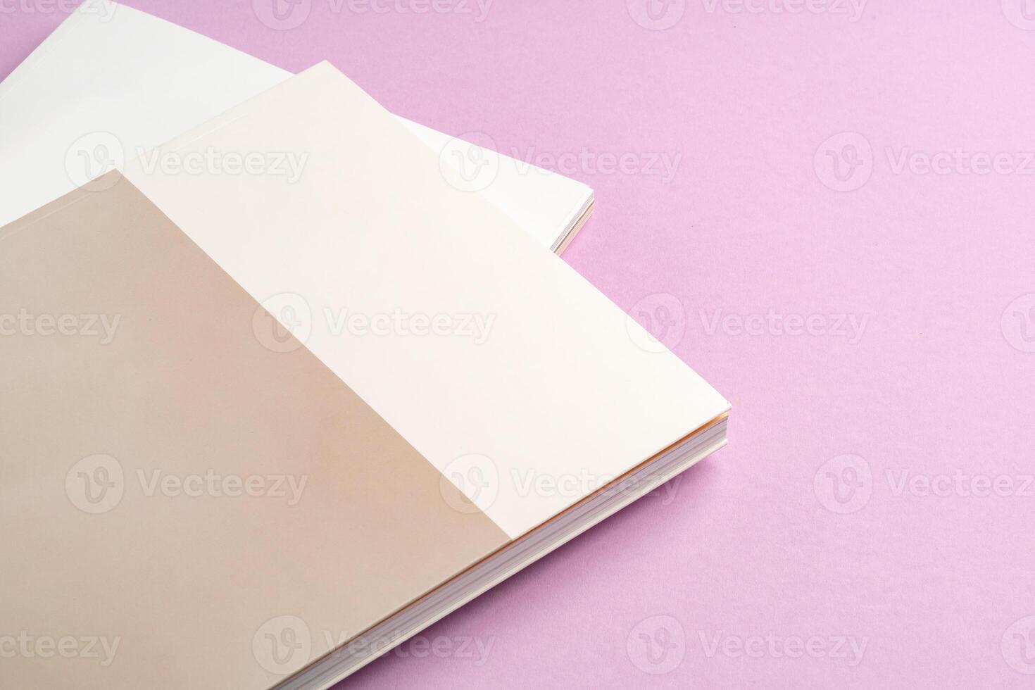 view of notebook with blank pages on a pink background photo
