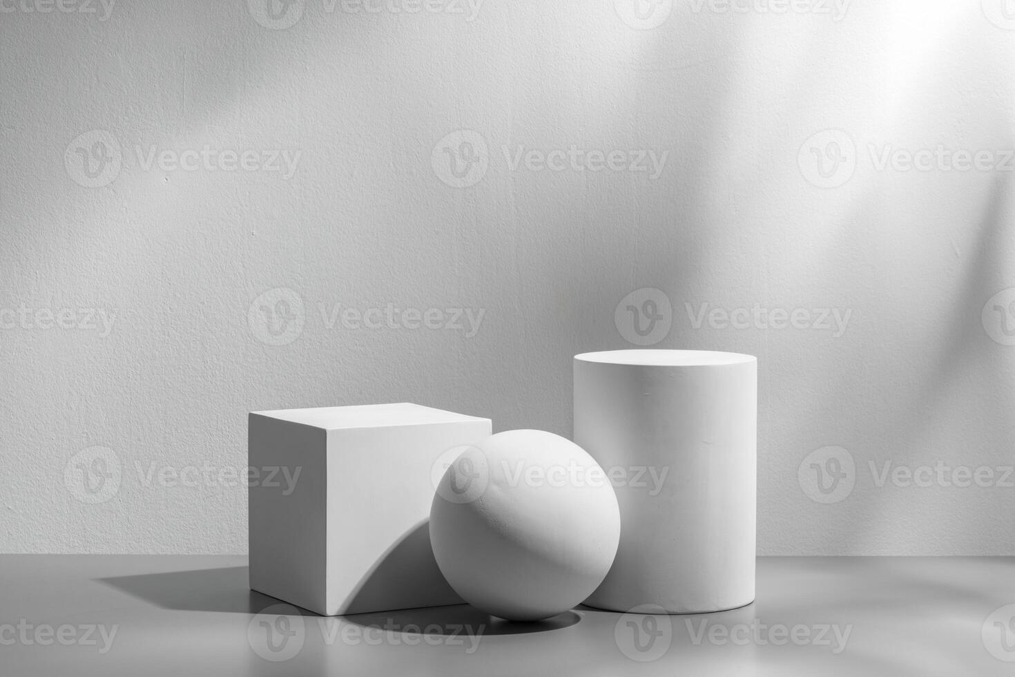 Abstract composition featuring three white geometric shapes in a minimalist interior setting photo