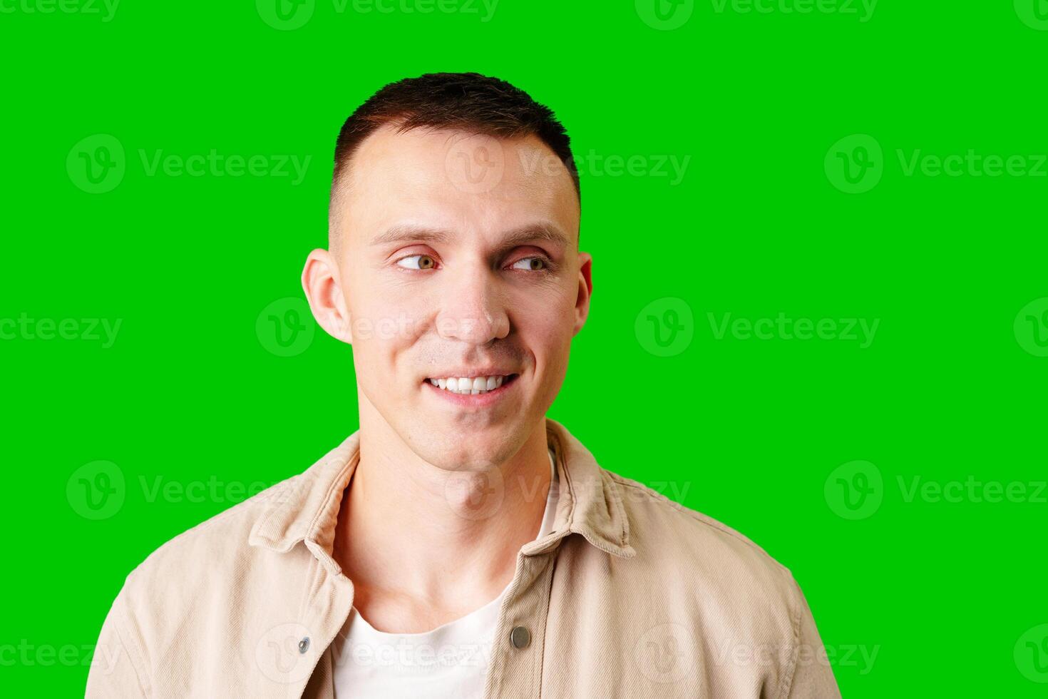 Smiling Man With Short Hair Posing Against Bright Green Backdrop photo