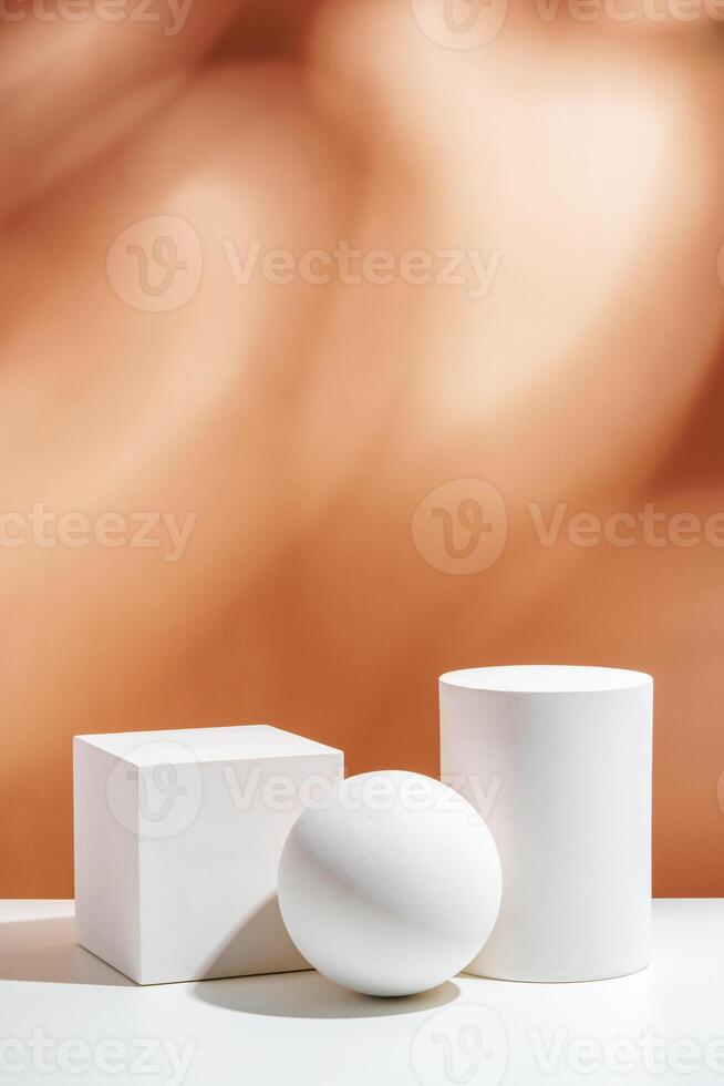 White geometric shapes arranged stylishly on a soft peach background in a minimalist setting photo