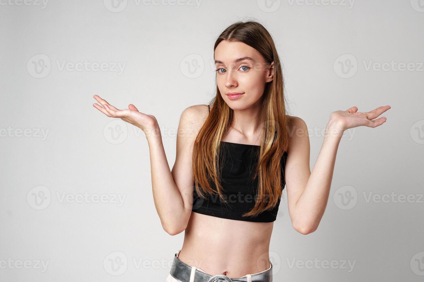 Young Woman in Black Crop Top and Cargo Pants With Hands Out photo