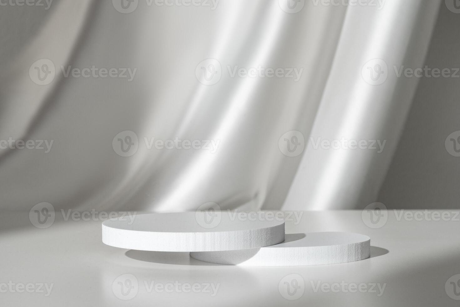 Modern Minimalist White Sculpture Displayed on Soft Draped Fabric in Natural Light photo