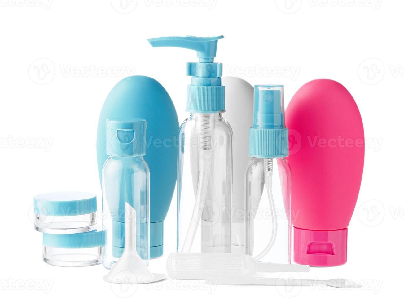 Clear plastic bottles with blue pumps and spray tops arranged on a white background photo