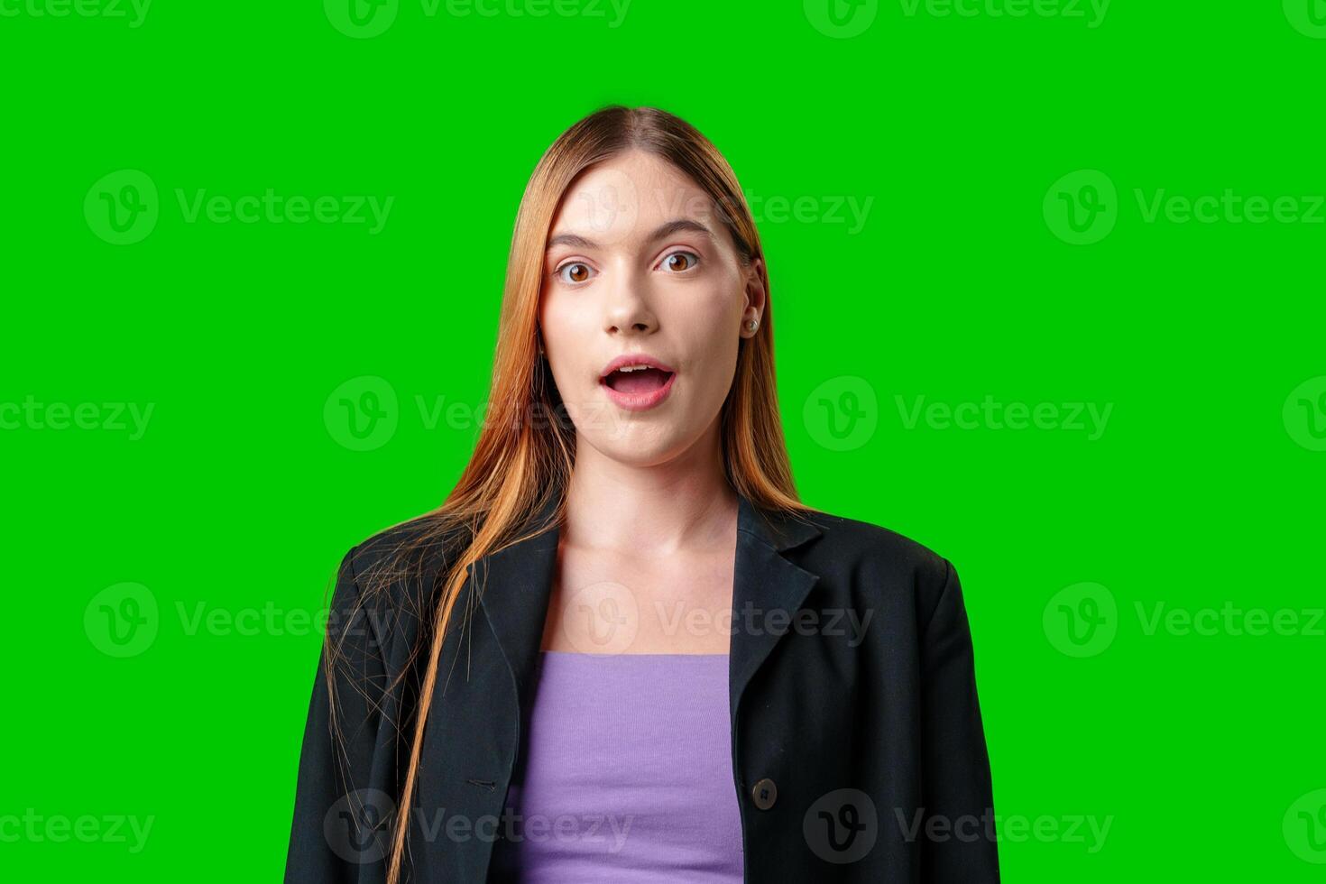 Young Woman With Surprised Expression in Front of Green Screen photo