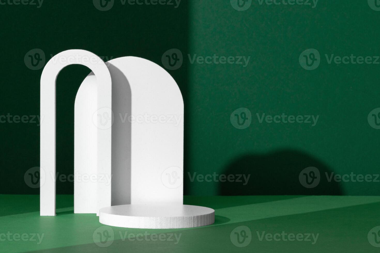 Modern White Architectural Shapes Against A Deep Green Background Displayed On A Simple Table Setting photo