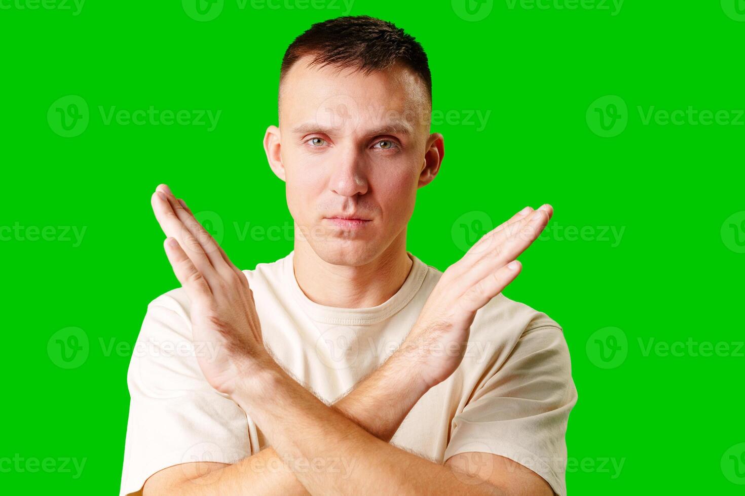 Man Gesturing No Signal Against Bright Green Background studio shot photo