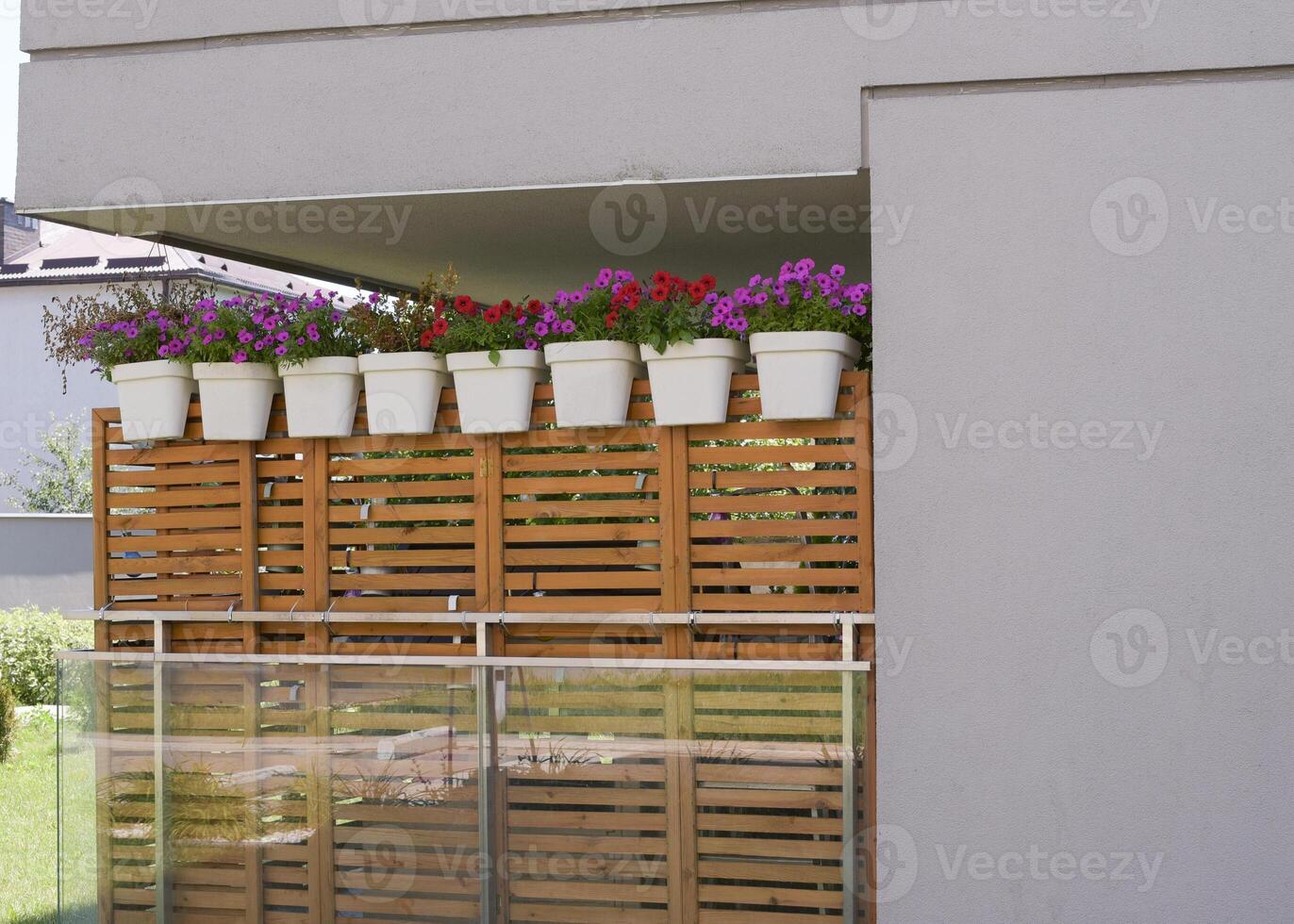 Wooden screen on the balcony with pots of flowers photo