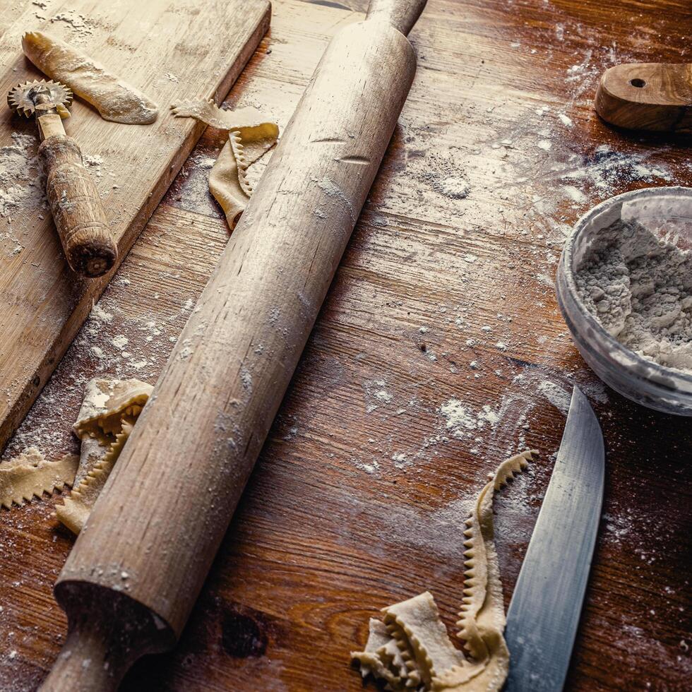 View of a cluttered kitchen table after making handmade dough. photo