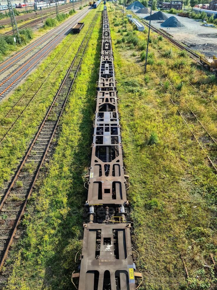 View of the tracks of a freight station with some wagons and numerous sidings. photo