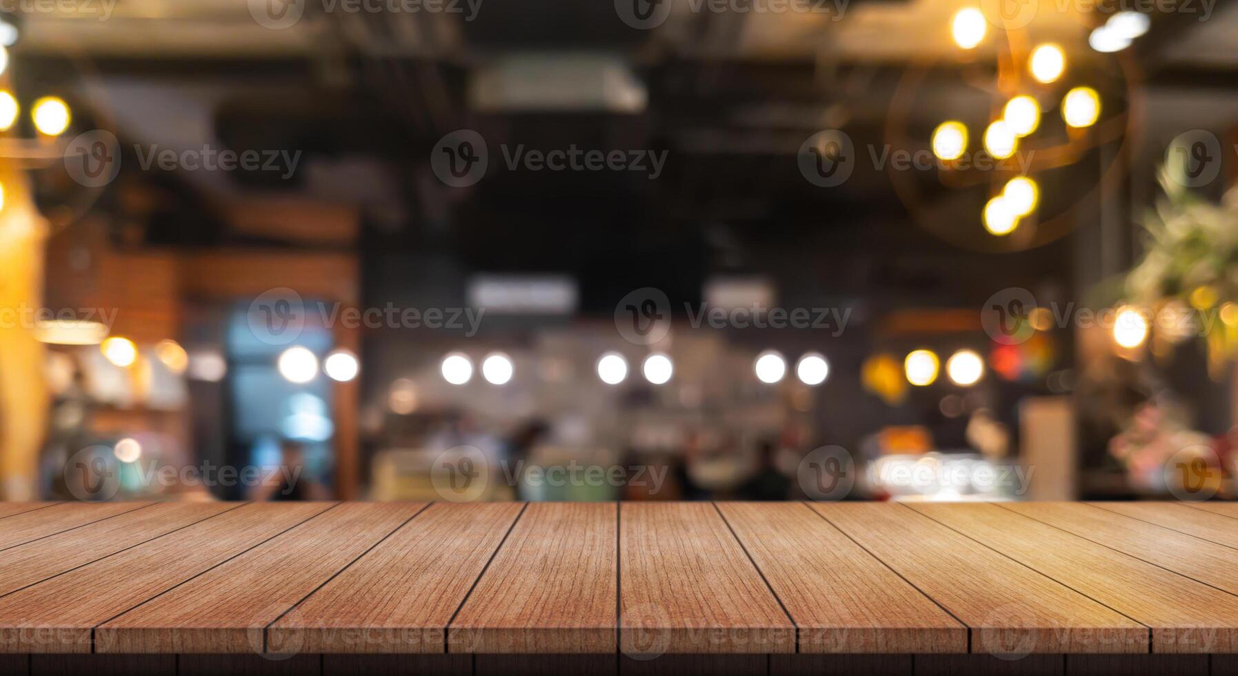Empty wooden table top with lights bokeh on blur restaurant background. photo