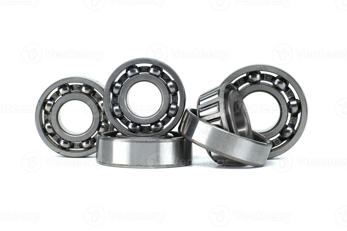 A collection of metal ball bearings in different sizes on a white background photo