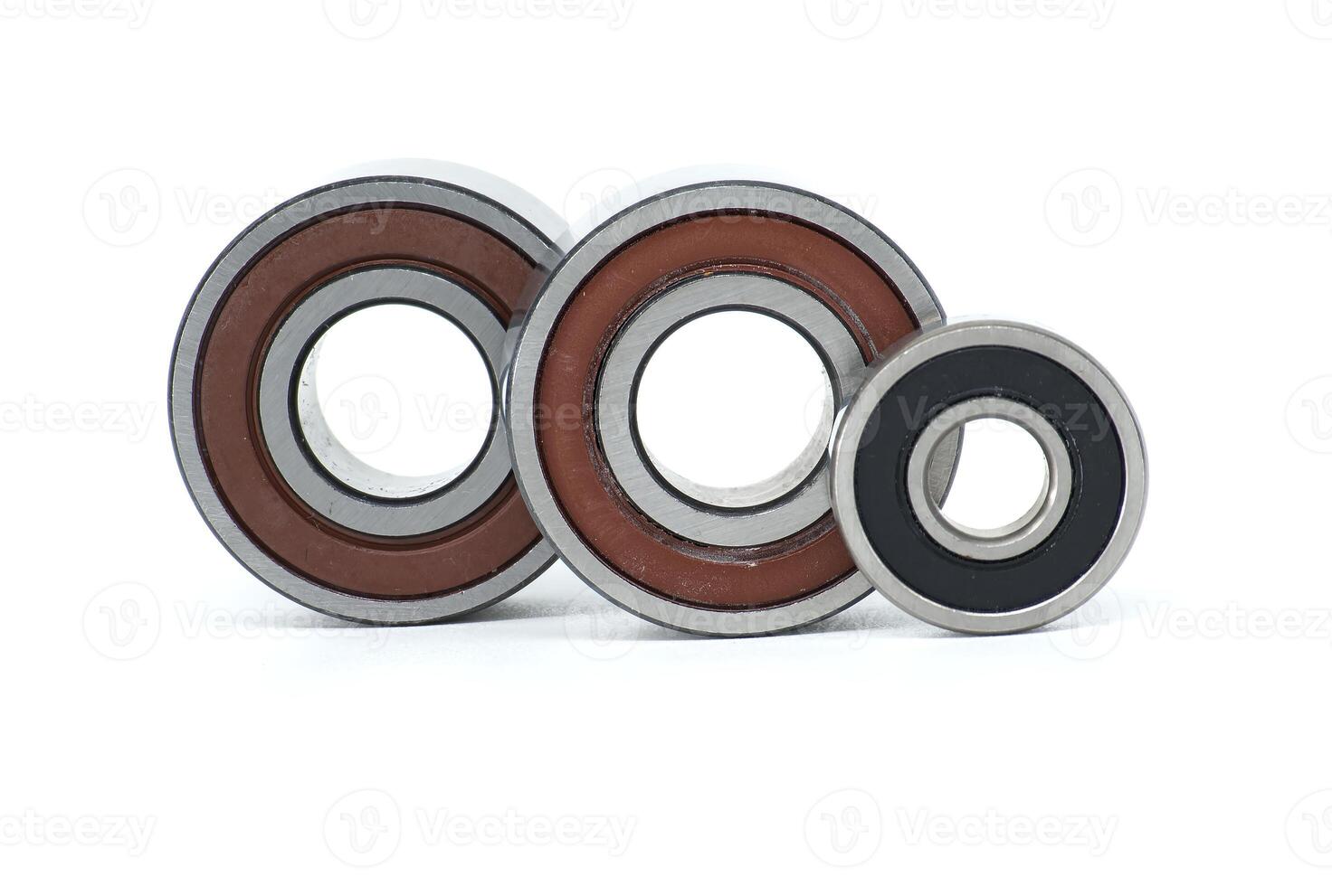 metal ball bearings of different sizes aligned on white background, showcasing engineering precision photo