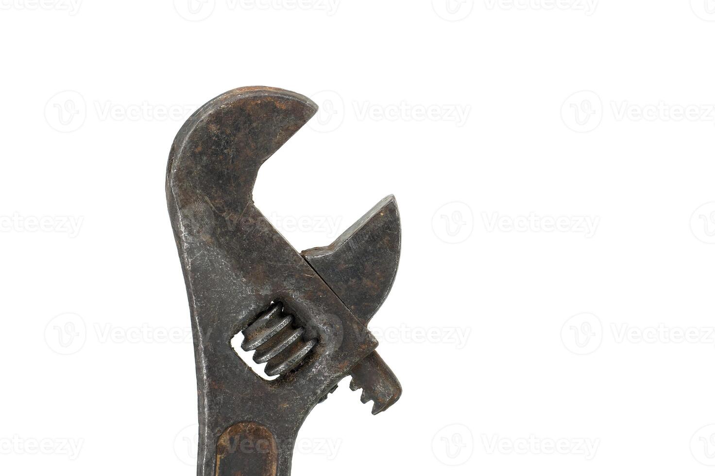 Close-up of an old and worn adjustable wrench with a rusty appearance isolated on a white background photo