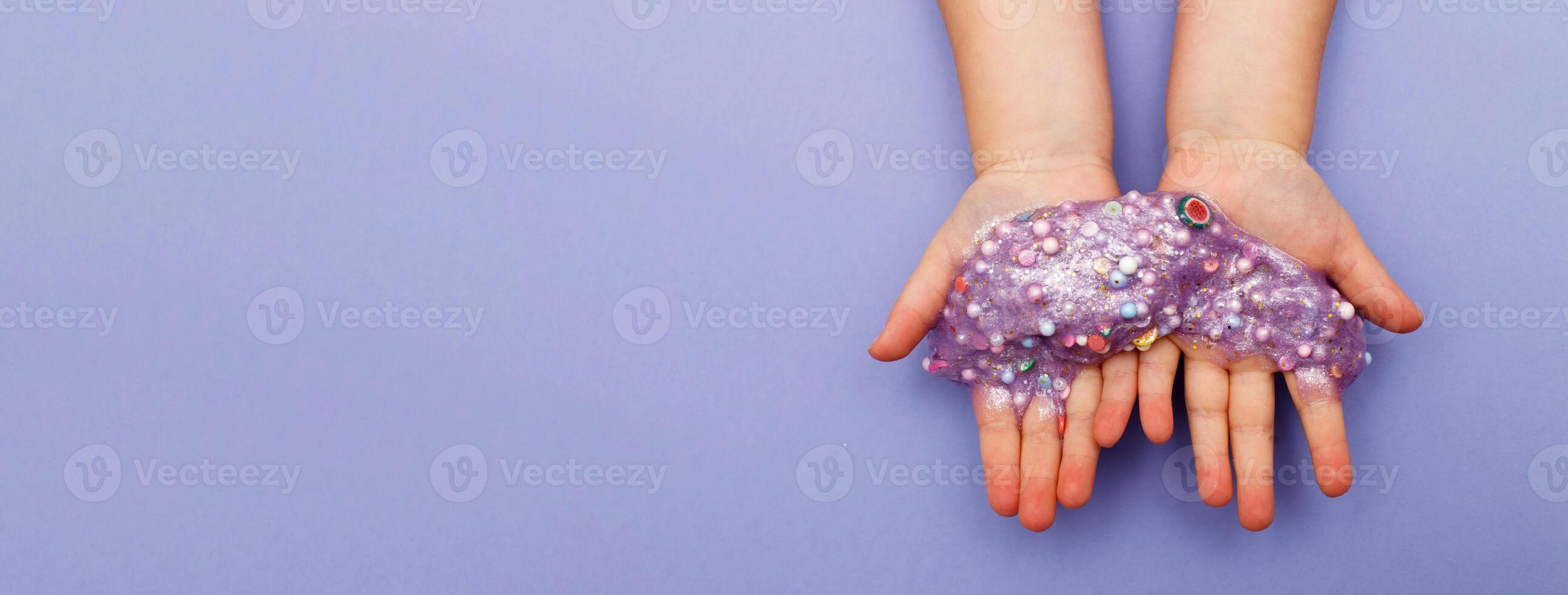 Making slime at home. child stretching colorful slime. DIY concept. Very Peri photo