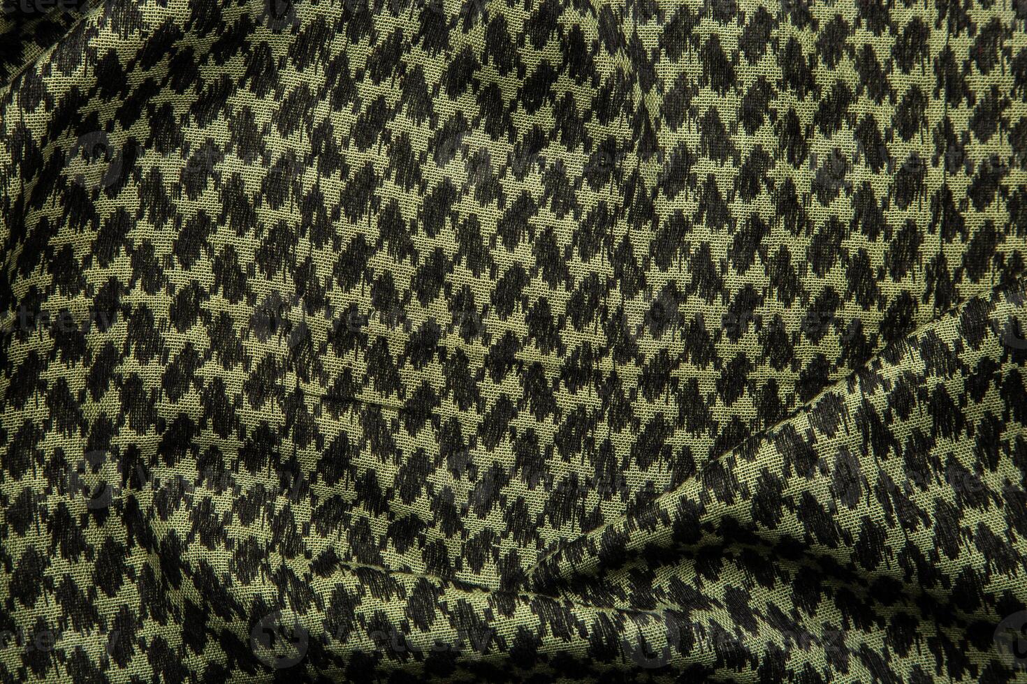 Keffieh scarf. The texture of the cotton traditional symbolic arabian scarf. Khaki back. photo