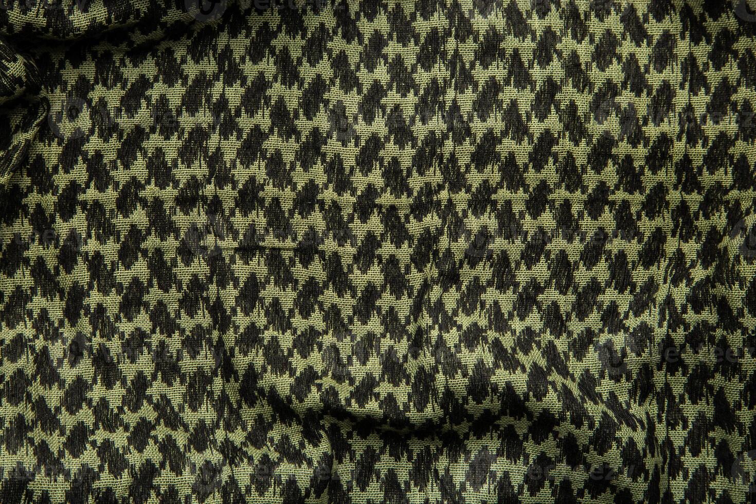 Keffieh scarf. The texture of the cotton traditional symbolic arabian scarf. Khaki back. photo