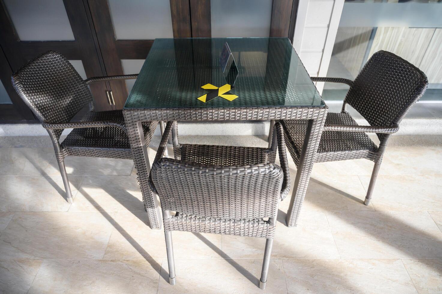 The marking on empty wooden table without nobody. Keep spaced between each chairs make separate for social distancing to avoid spreading of Covid-19. Social distance concept. photo