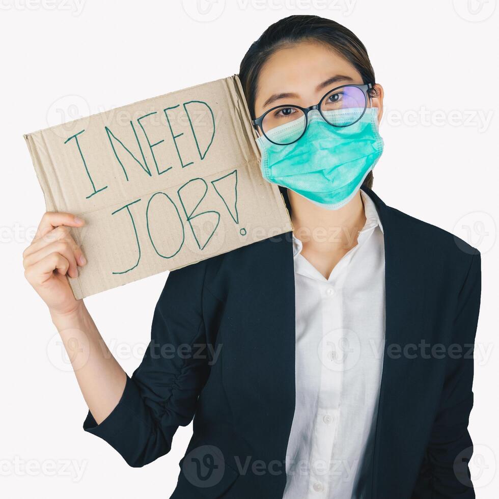 Young business woman wearing surgical mask and holding a sign paper for seeking a job isolated on white background. photo