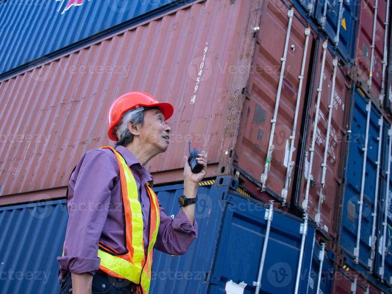 Talkie walkie speak talk person people male labor employee control import export container frieght industry trading commercial shipping business delivery nautical marchandise storage vessal engineer photo