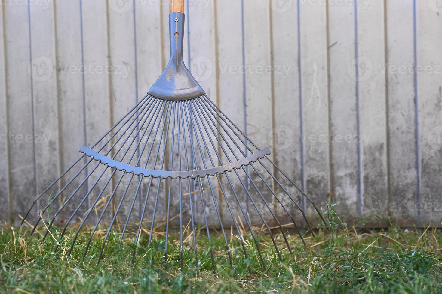 Gray metal plastic mop sweeping trash in the yard photo