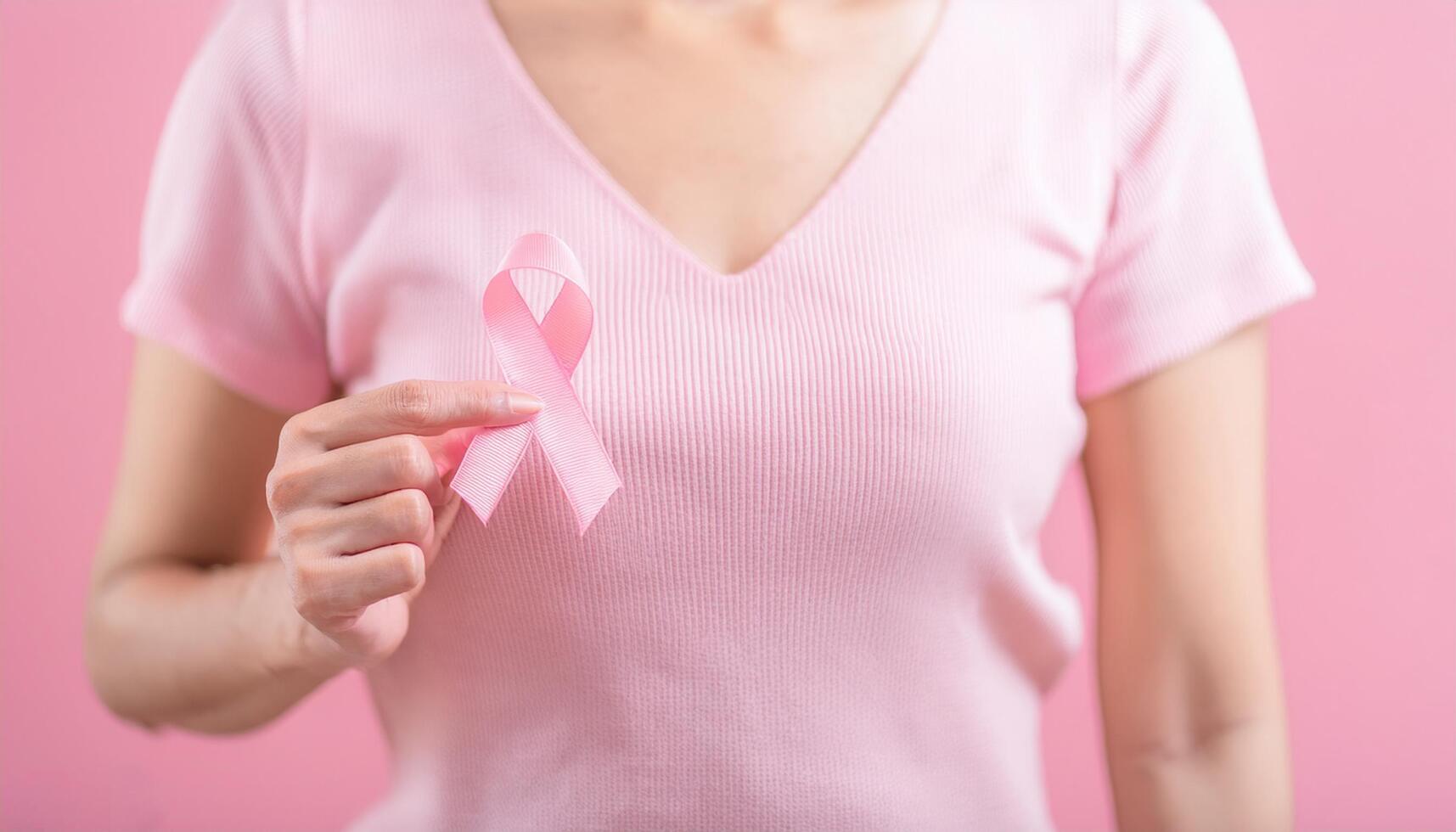 Women holding pink ribbon, breast cancer awareness concept photo