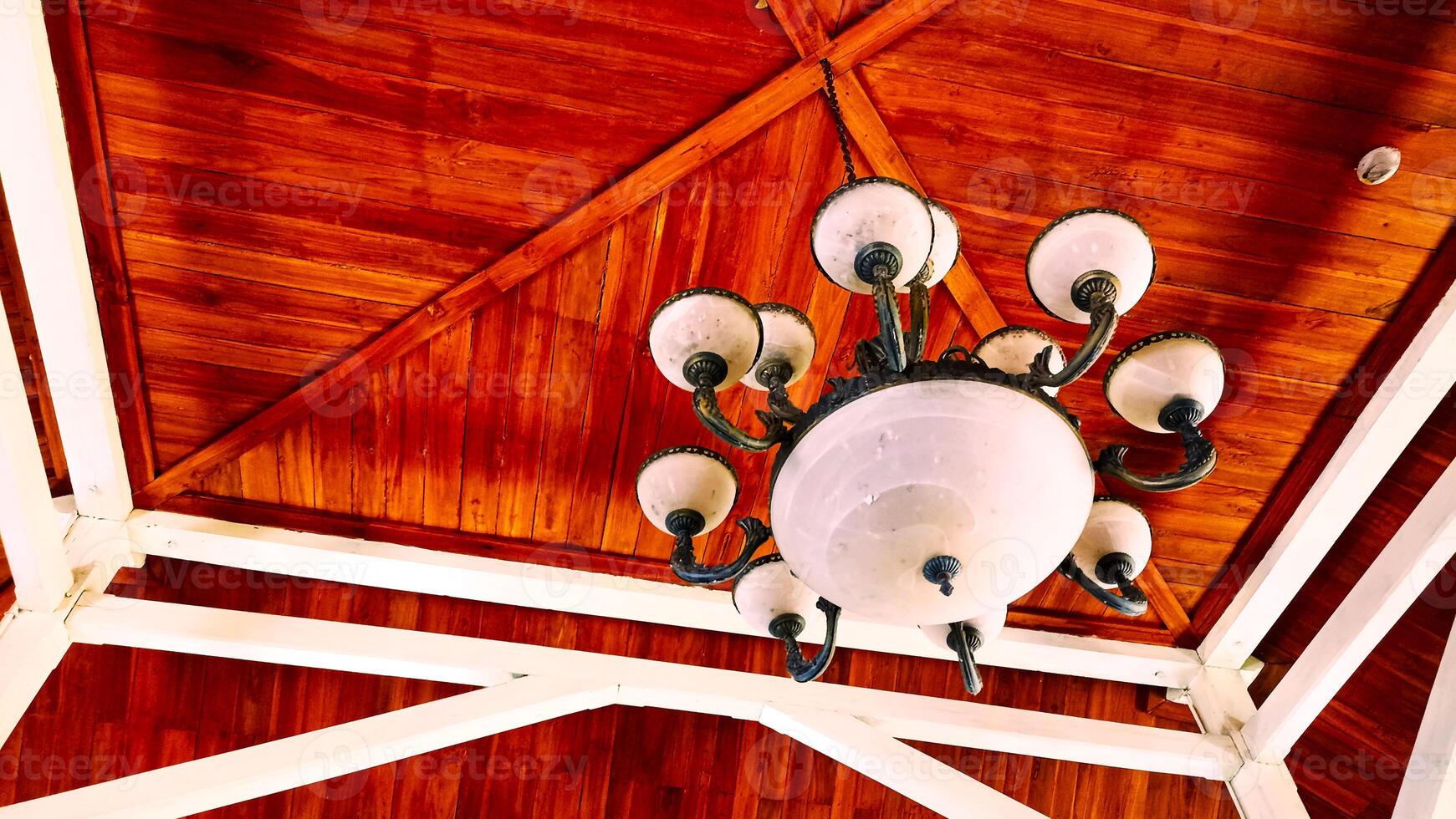 a chandelier hanging from the ceiling of a wooden building photo