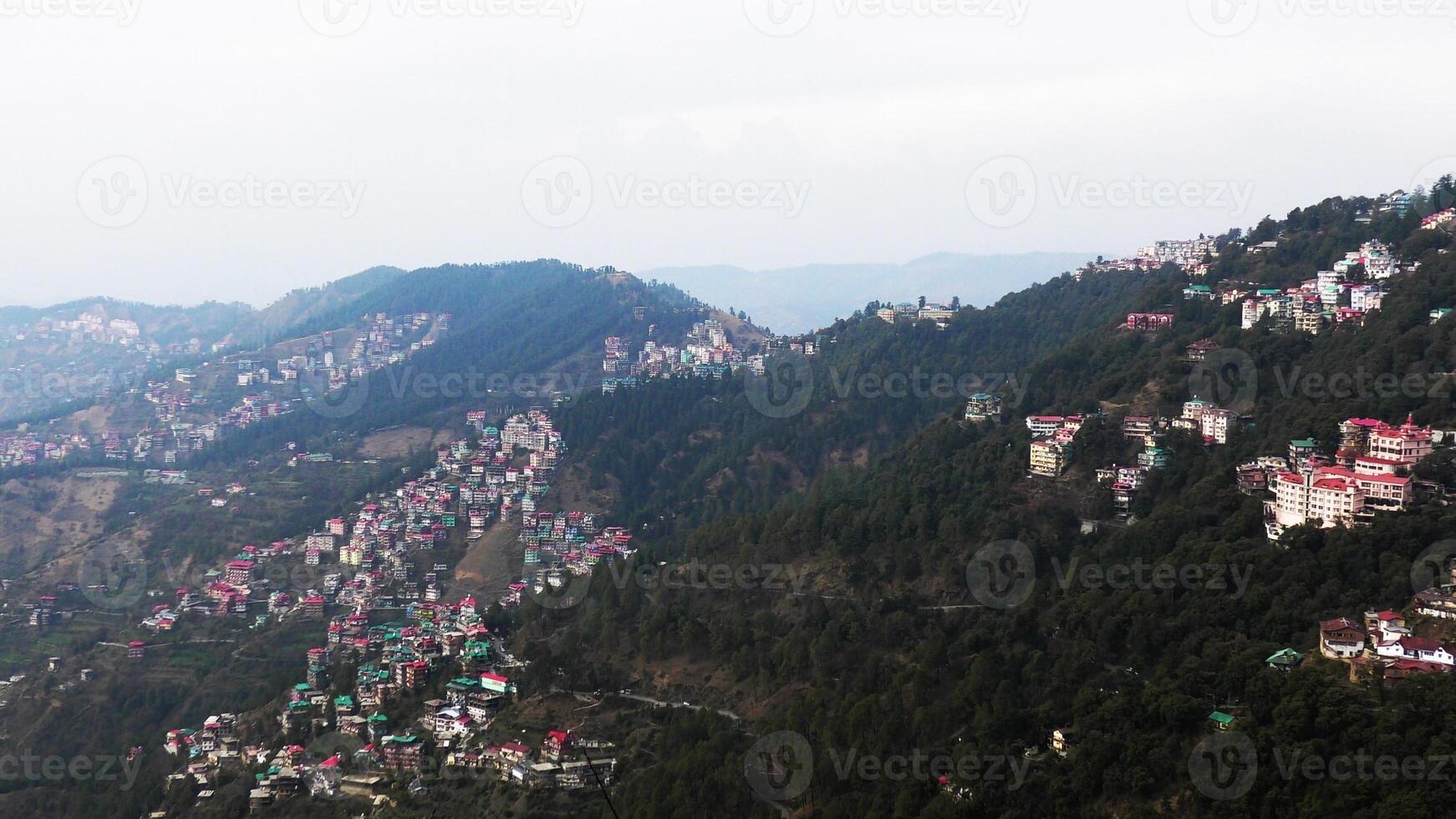 A hilly landscape full of residential complexes in Himachal Pradesh, India photo