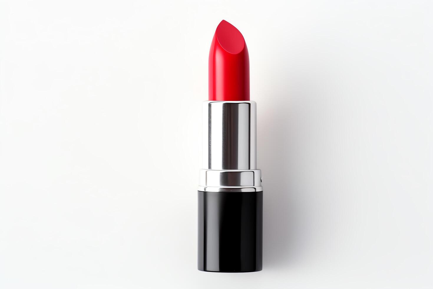A single tube of red lipstick sits on a white background. The lipstick is unworn and the cap is on. photo