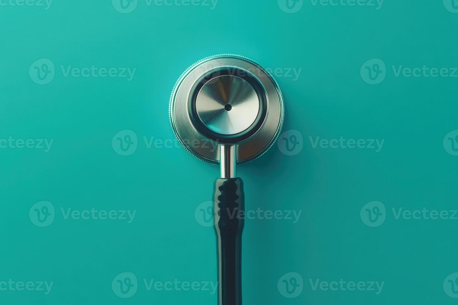 The stethoscope lies alone against a rich teal backdrop, symbolizing the connection between healthcare professionals and patients photo