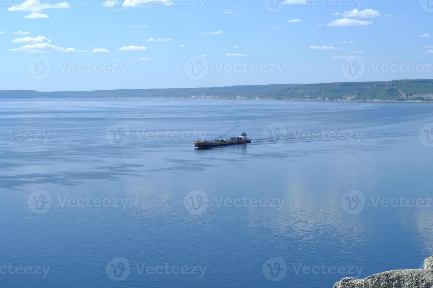 A cargo ship is sailing on the river Volga photo