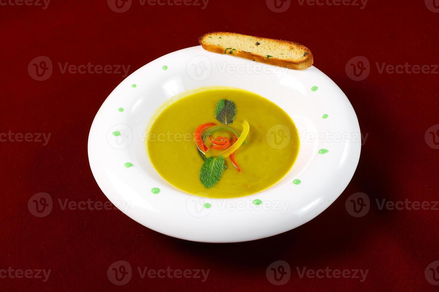 Creamy Butternut Squash Vegetable Soup with Herbs and bread served in bowl isolated on red background side view of arabic food photo