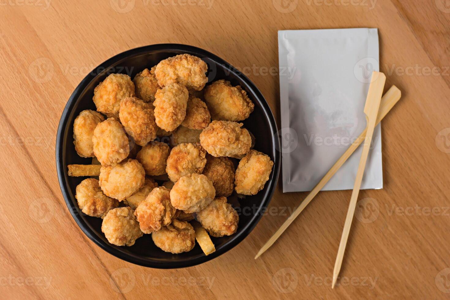 Crispy Chicken Popcorn with Dipping Sauce served in plate isolated on wooden table top view fast food snacks photo