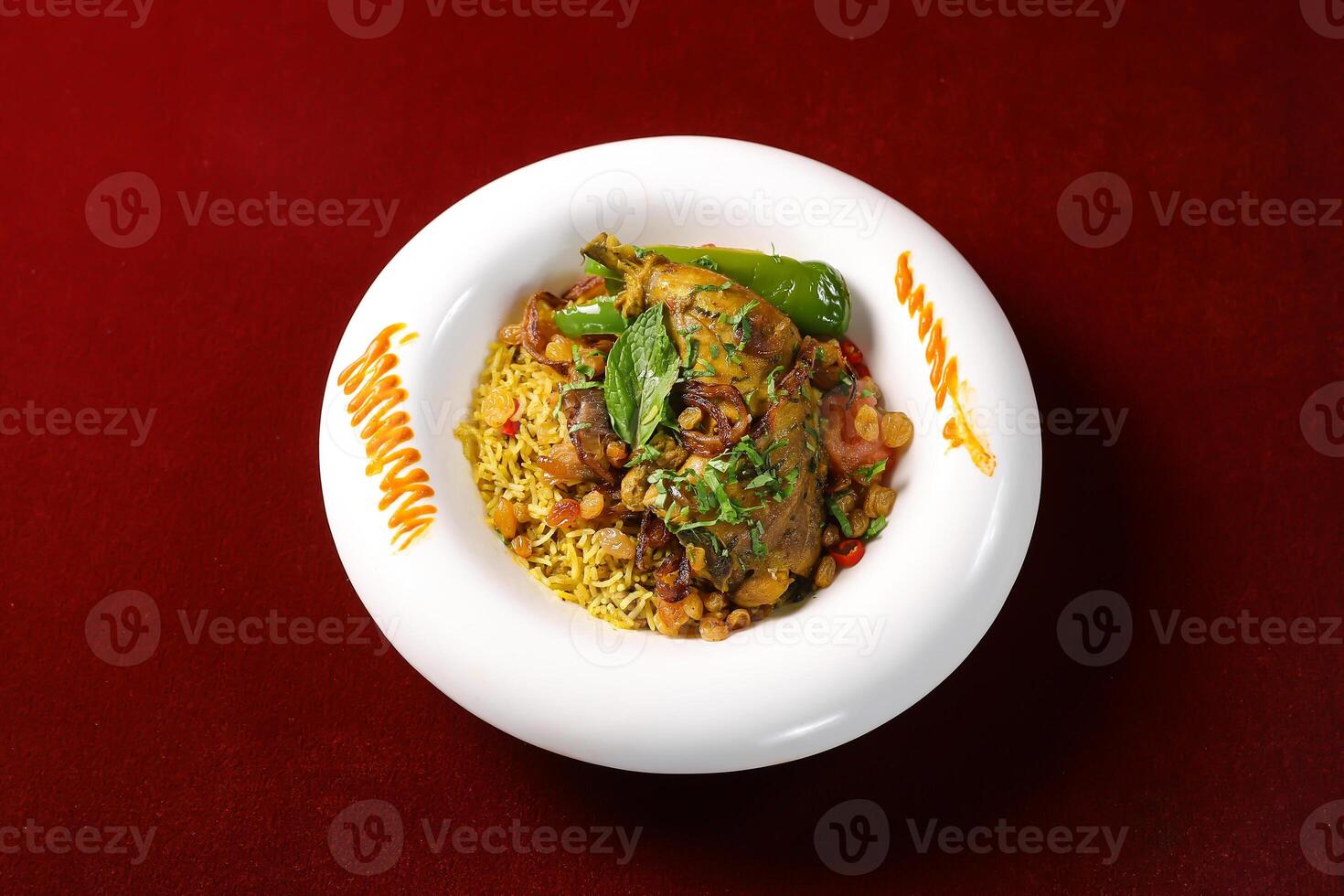 Chicken Kabsa biryani Rice with fried onion mint and coriander served in broth side view of arabic food on red background photo