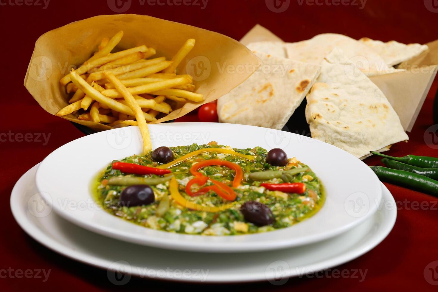kafteji plate Tunisian Salad with French Fries and Pita Bread served in plate isolated on red background closeup side view of arabic food photo